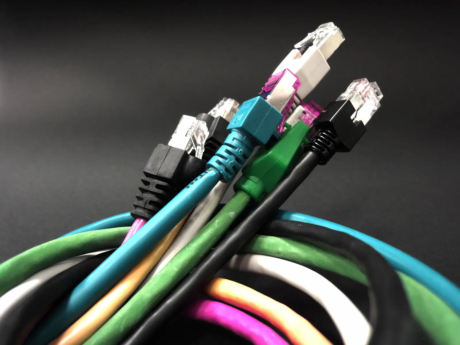 Bundle of colour-coded RJ45 network cables — representing the complete low-current cabling package