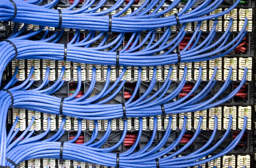 Cat6 network cabling running across a server patch panel in an enterprise data closet